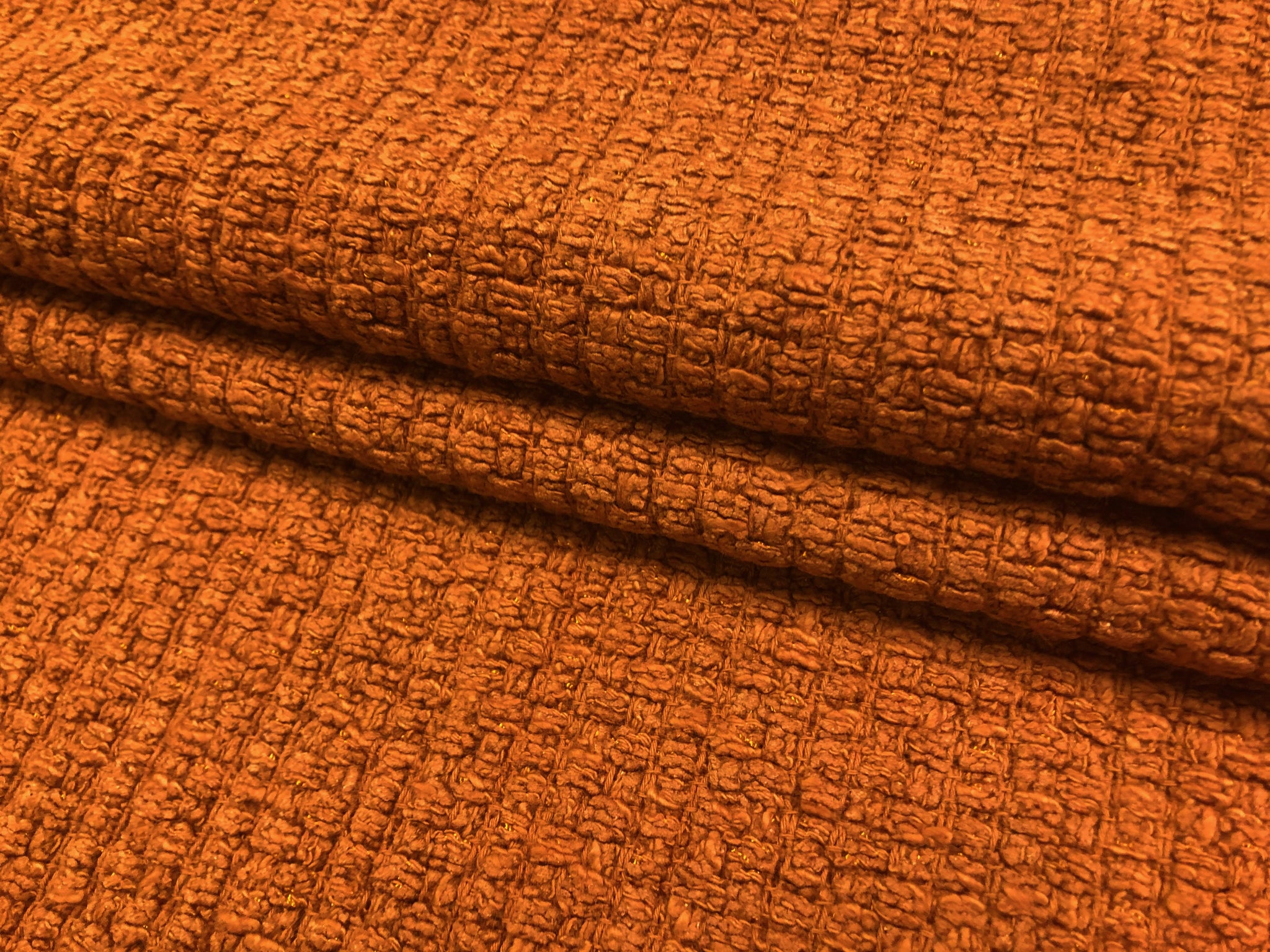 Closeup of terracotta bouclé fabric texture